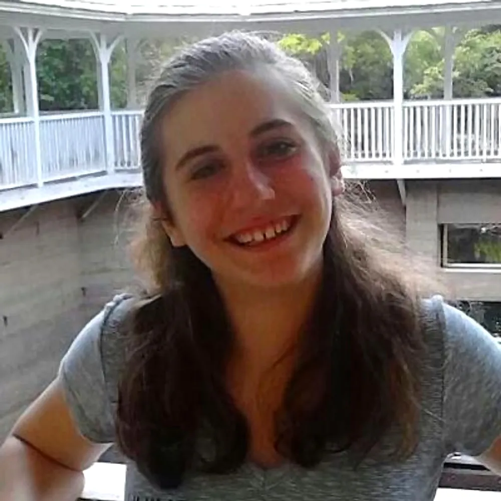 Lillian Riggs smiling inside a white gazebo during her Hofstra years